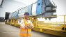 Gibela procurement executive Colette Yende stands outside in front of a train set at Gibela's premises