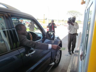 IMPROVED MOBILITY  Zimbabwe Transport, Communications and Infrastructural Development Minister Nicholas Goche pays at the Ntabazinduna toll plaza outside Bulawayo