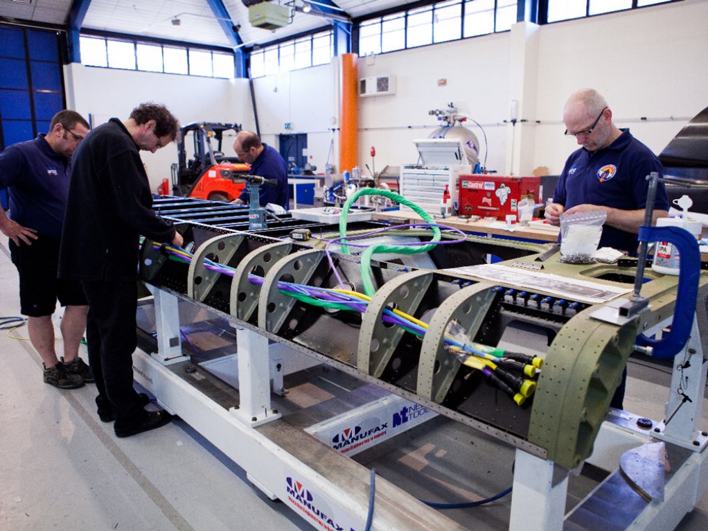 Mechanics and engineers thread the 2.2 km wiring loom