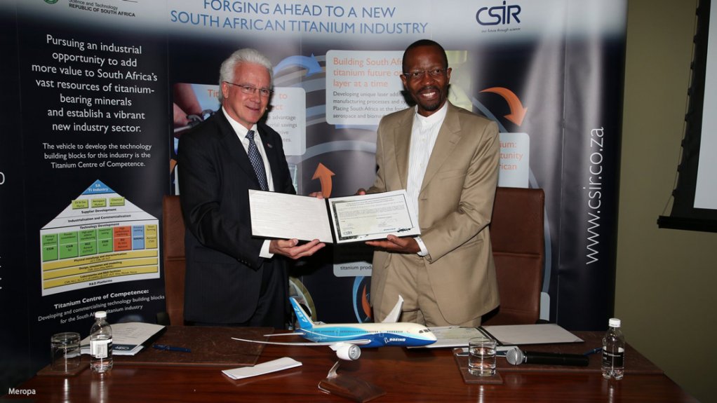 Boeing International VP Miguel Santos and CSIR CEO Dr Sibusiso Sibisi display the MoU they have just signed