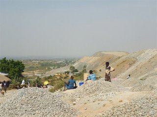 Local villagers regularly gather rocks at the North Mara mine in the hope of finding gold