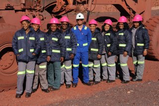 TRAILBLAZERS The eight trainees who recently qualified as grader operators with their training instructor, Thabiso Masegela