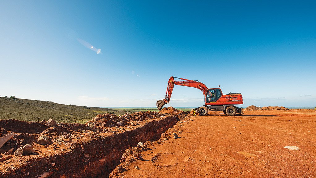CABELLING Excavator digs a trench for the laying of cables 