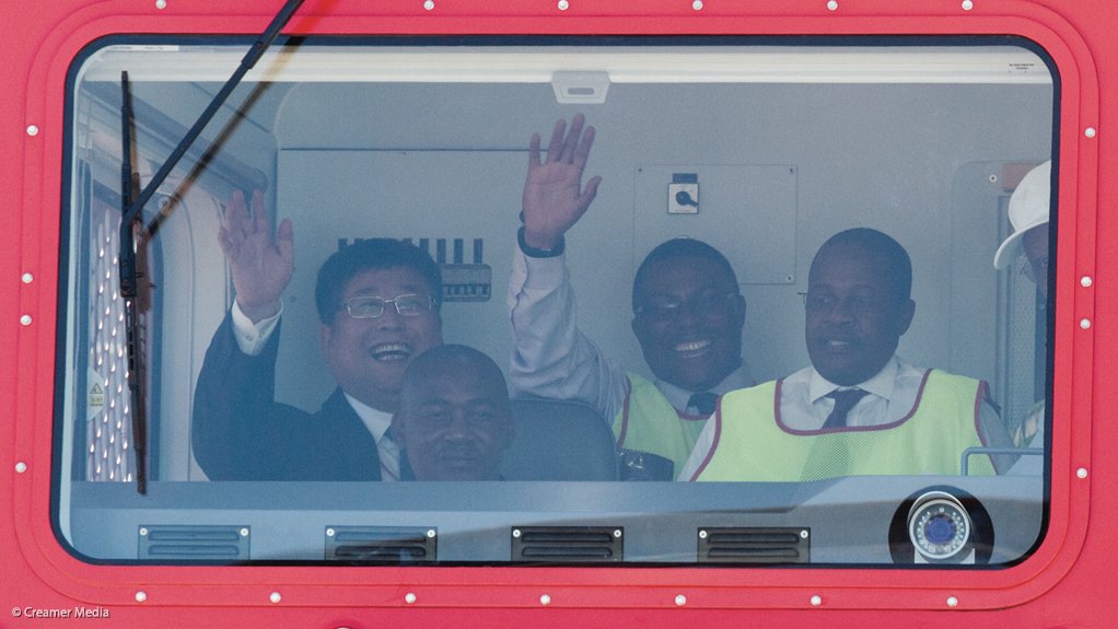Zhou Qinghe, Siyabonga Gama and Brian Molefe inside the cab of the first Class 20E locomotive, which is still undergoing tests