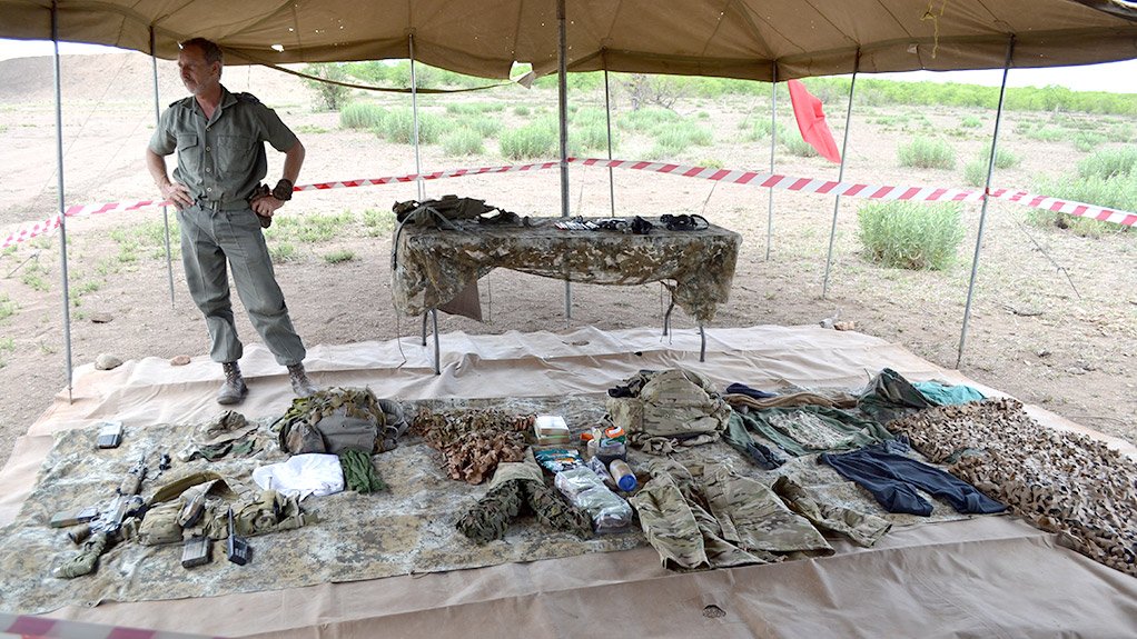 BRUCE LESLIE Special tactics trainer and antipoaching head Bruce Leslie stands next to equipment used by the antipoaching unit