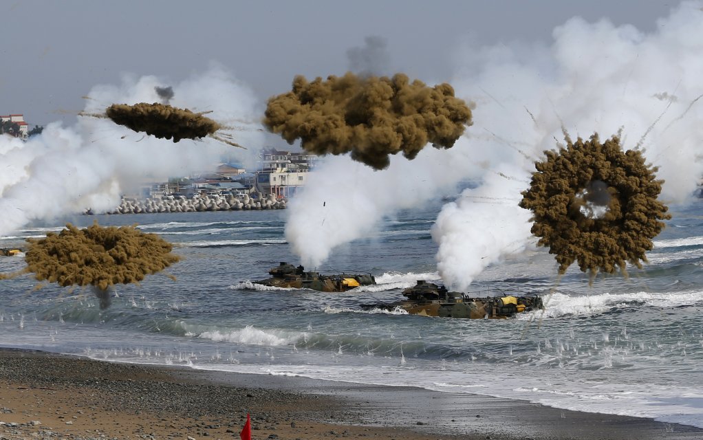 EXPLOSIVE TRAINING: Amphibious assault vehicles of the South Korean Marine Corps throw smoke bombs as they move to land on shore during a recent US-South Korea joint landing operation drill in Pohang. The drill is part of the two countries' annual military training called Foal Eagle, which began on February 24 and runs until April 18.