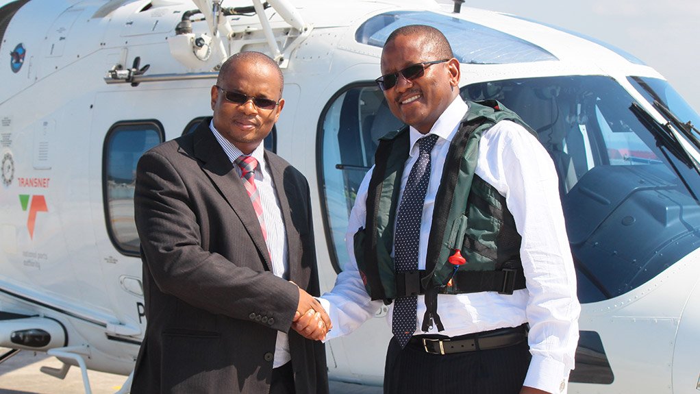 TNPA Chief Harbour Master Rufus Lekala (left) and Denel CEO, Mike Kgobe, celebrate the awarding of the contract at the TNPA’s helipad in Durban