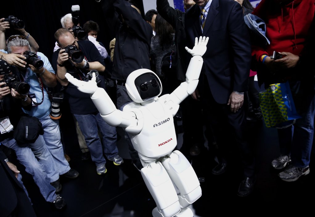 STAR QUALITY: The Honda Motor Company’s Asimo robot runs a gauntlet of photographers after a recent presentation during the 2014 New York International Auto Show, in the US city. Asimo stands for ‘Advanced Step in Innovative Mobility’ and has made remarkable progress since its first public introduction 14 years ago. Asimo even played a game of football with President Barack Obama during the US leader’s recent visit to Japan.