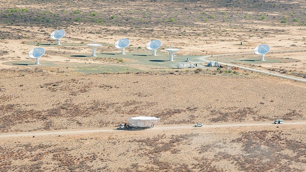 PRESENT AND FUTURE: A MeerKAT main reflector dish is driven past the KAT-7 radio telescope array 