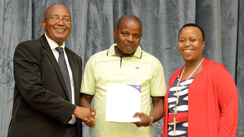 From left - right)  - DR SNP Sishi - Head of Department , Education KZN with Wanda Gwala representing the to achiever in Matric 2014 Ngcebo Gwala (not in the picture) and Thandeka Cele , Public Affairs Manager at ENGEN