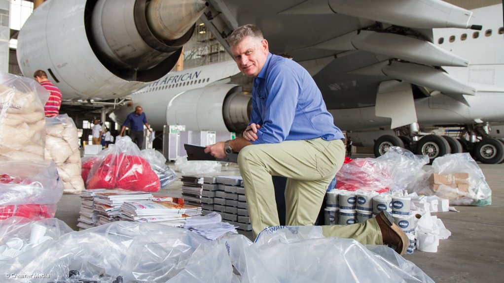 Captain Sandy Bayne with just some of the material taken off the A340-600 in the background, after its return from Munich