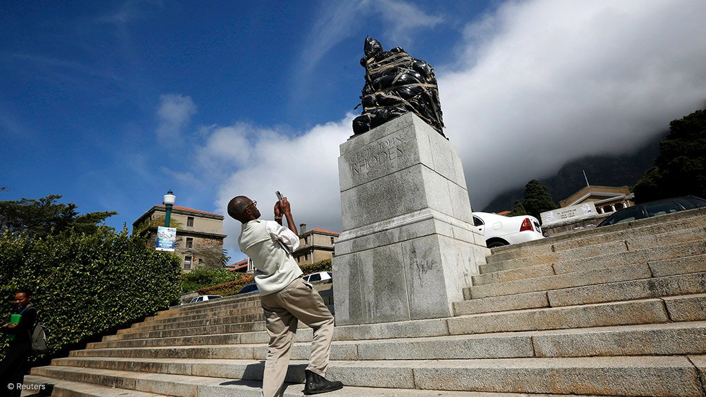 A student takes a photo before the Rhodes statue is removed from UCT