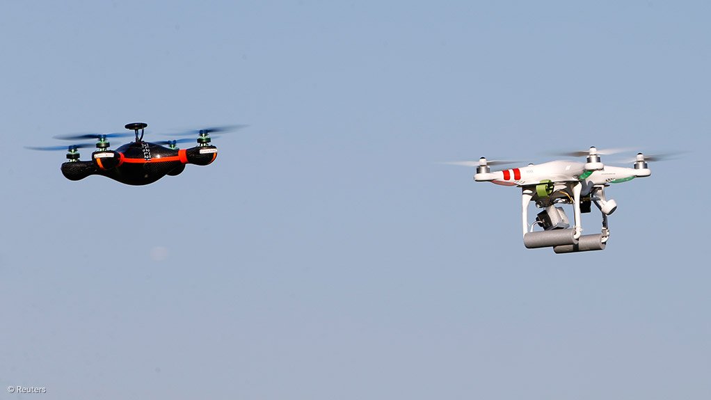 Two different types of quadcopter RPAs in flight, with the one on the right carrying a camera