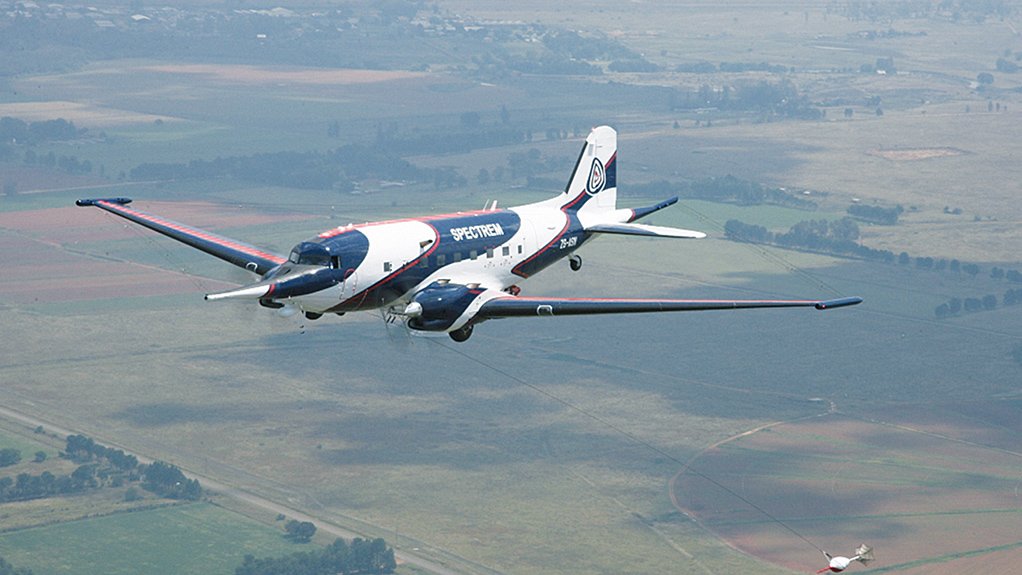 POWERFUL PLATFORM: Spectrem’s survey DC-3. Note the aeromagnetic survey “bird” being towed below and behind the aircraft. Just visible are the aerials running from the wingtips to the tail boom and from the wingtips to the nose probe. The exhaust for the auxiliary power unit can be seen in the upper fuselage, above the engine