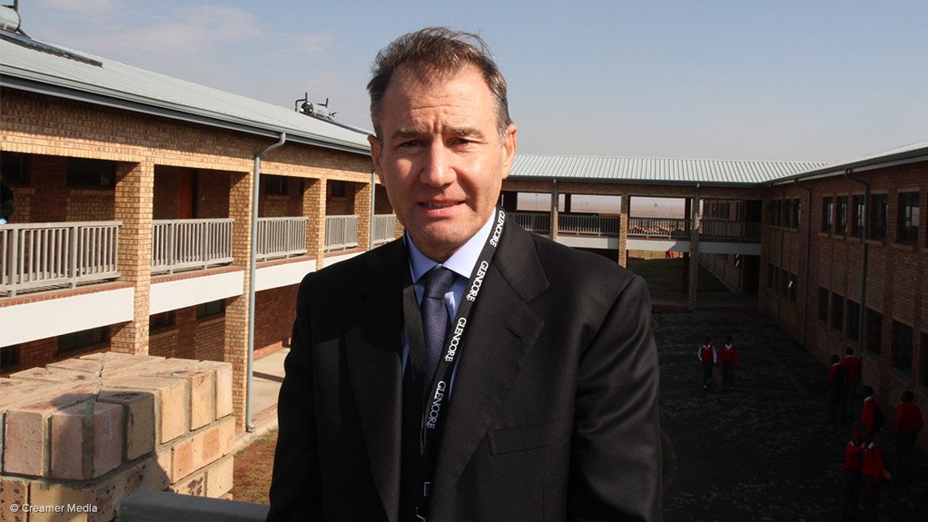 Ivan Glasenberg, backgrounded by the South African school Glencore funded.
