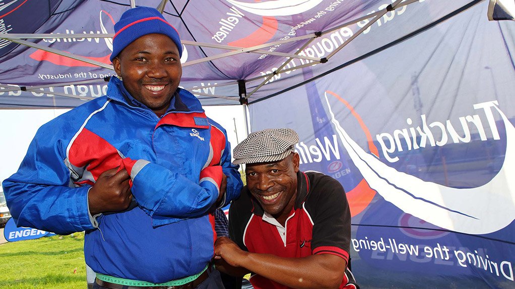 Buyisiwe Jubase of Engen getting his waist measured by Stephan Mokhesi a councillor from Corridor Empowerment project ( CEP ) at a truck stop in East London