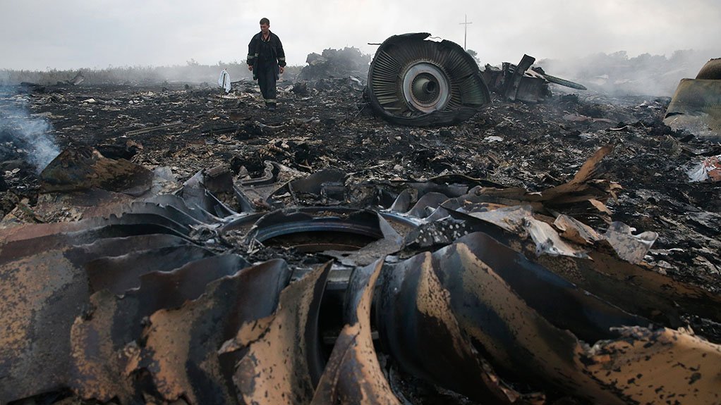 VICTIM OF CONFLICT The wreckage of Malaysia Airlines Boeing 777-2H6ER, registration 9M-MRD, which was shot down over eastern Ukraine while operating Flight MH17. The man is a member of Ukraine’s Emergency Ministry
