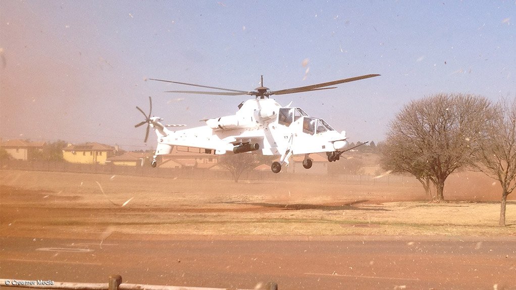 A Denel Aviation Rooivalk helicopter, painted in United Nations white, taking off