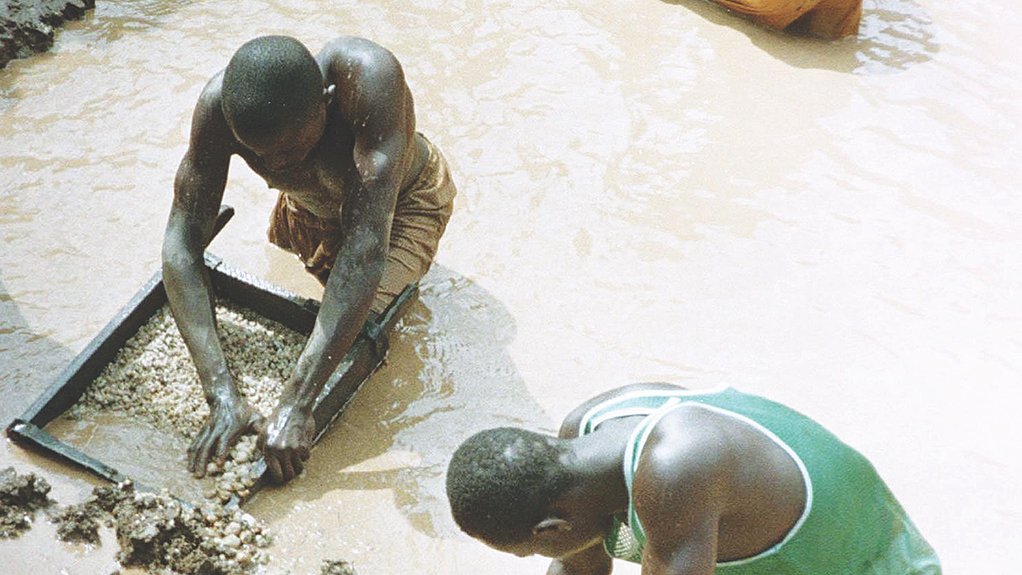 BEING FORMALISED THROUGH COOPERATIVES Angolan artisanal miners panning for diamonds
