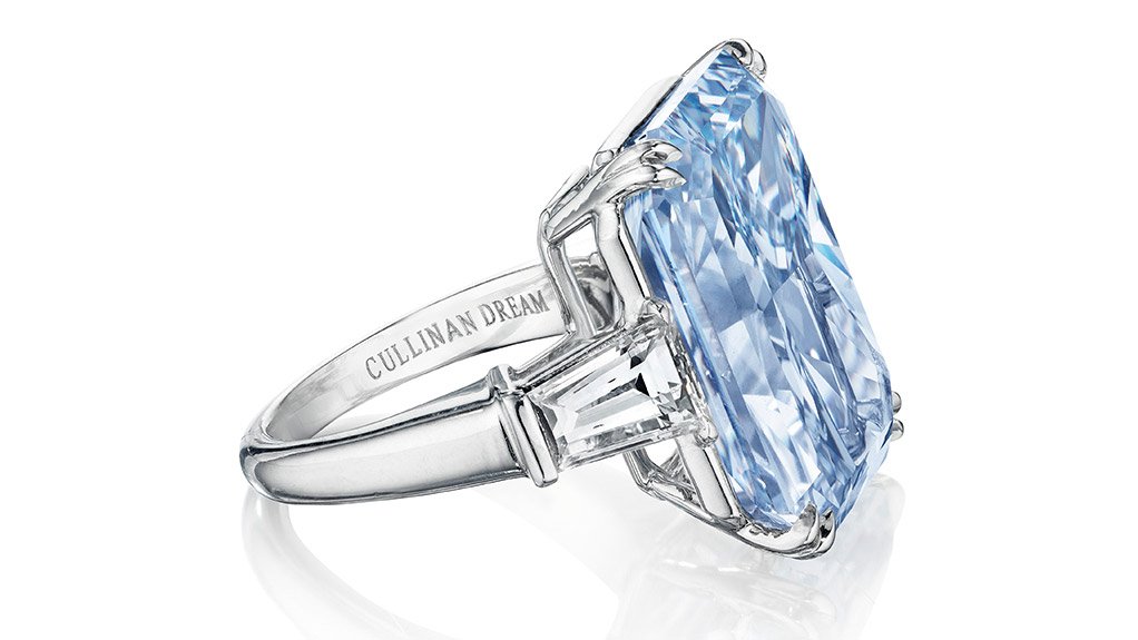The cut-cornered rectangular mixed-cut fancy intense blue Cullinan Dream diamond, flanked on either side by a tapered baguette-cut diamond, weighing a combined 2.36 ct, is mounted in a size six platinum ring