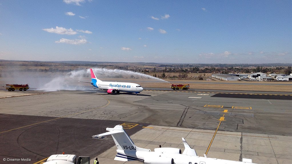 The first FlySafair aircraft to operate a scheduled service into Lanseria receives a water spray salute to welcome it to the airport
