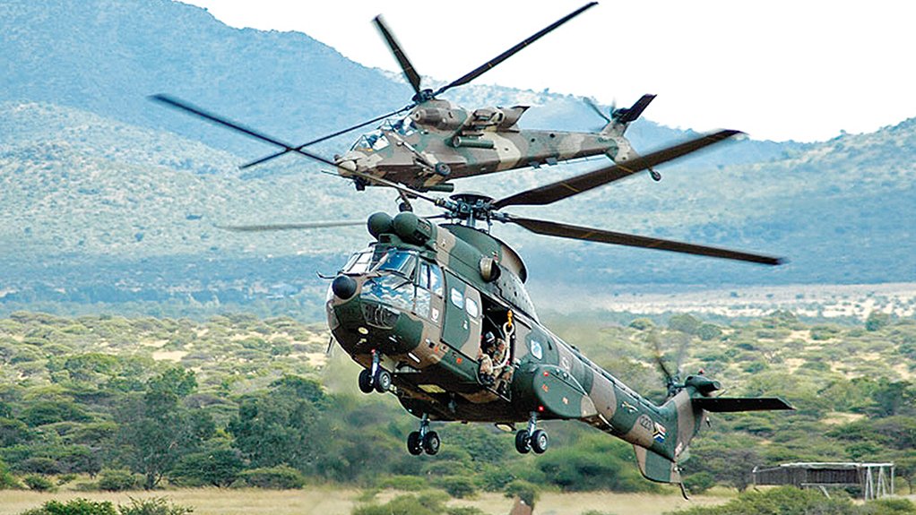  	LOCALLY DEVELOPED Two Denel products undertake a joint display – in the foreground, an Oryx medium utility helicopter and, behind it, a Rooivalk attack helicopter