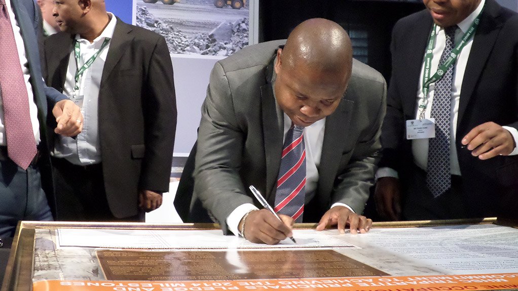 RENEWED COMMITTMENT Cooperative Governance and Traditional Affairs Minister Des van Rooyen signs mining industry pledge renewal on achieving health and safety milestones agreed in 2014 