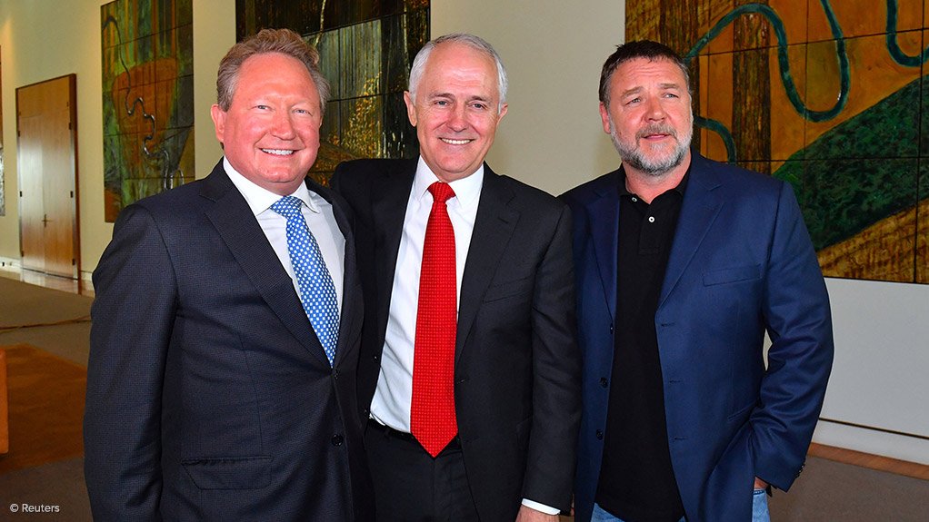 Australian mining magnate Andrew Forrest stands with PM Malcolm Turnbull and actor Russell Crowe as they attend a ceremony announcing his pledge in Canberra.