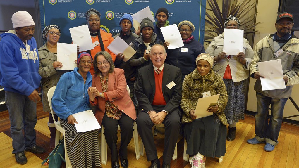 NEW TITLE DEED HOLDERS Cape Town Mayor Patricia de Lille and business person Christo Wiese presenting titles deeds to residents in Western Cape 