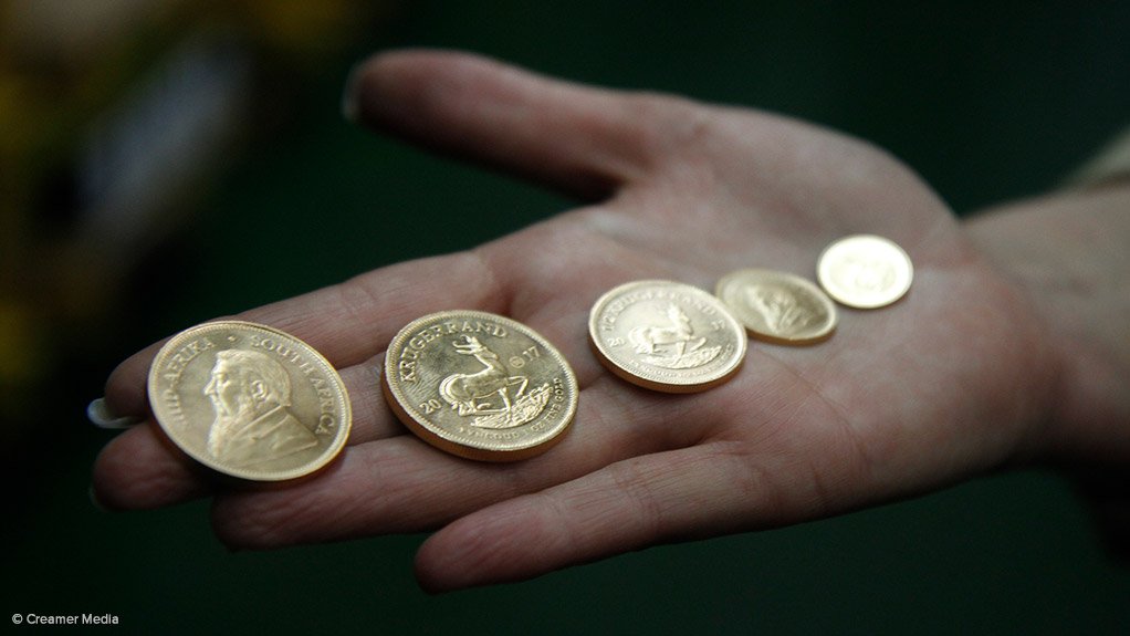 Gold bullion Krugerrands in the palm of your hand
