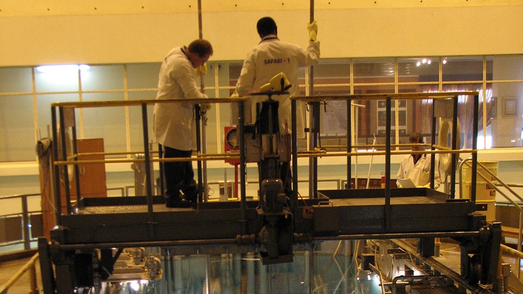 LIFESAVER Necsa reactor specialists stand on top of Safari-1, shielded by the water enveloping the reactor core. The blue light (Cherenkov radiation) shows the reactor is operating