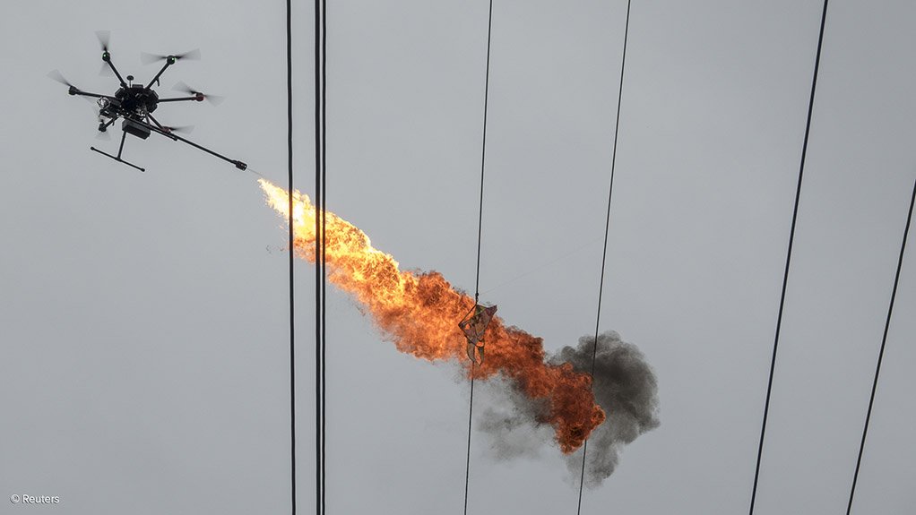 INTERESTING APPLICATIONS The list of potential applications that can benefit from using RPASes is growing daily. Seen here, a drone operated by staff of Hainan Power Grid Corporation emits flames to burn down trash from power lines in Haikou, China