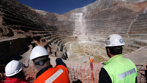 Workers stand next to an open pit at Barrick Gold's Veladero gold mine, in Argentina's San Juan province