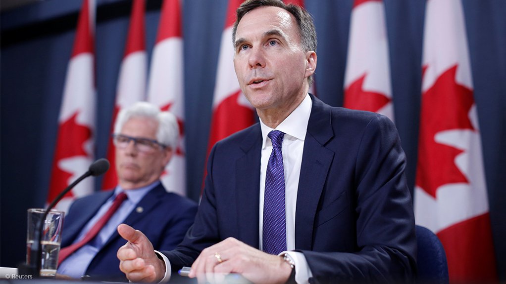 Canada's Finance Minister Bill Morneau speaks while Mining Minster Jim Carr listens during a news conference in Ottawa