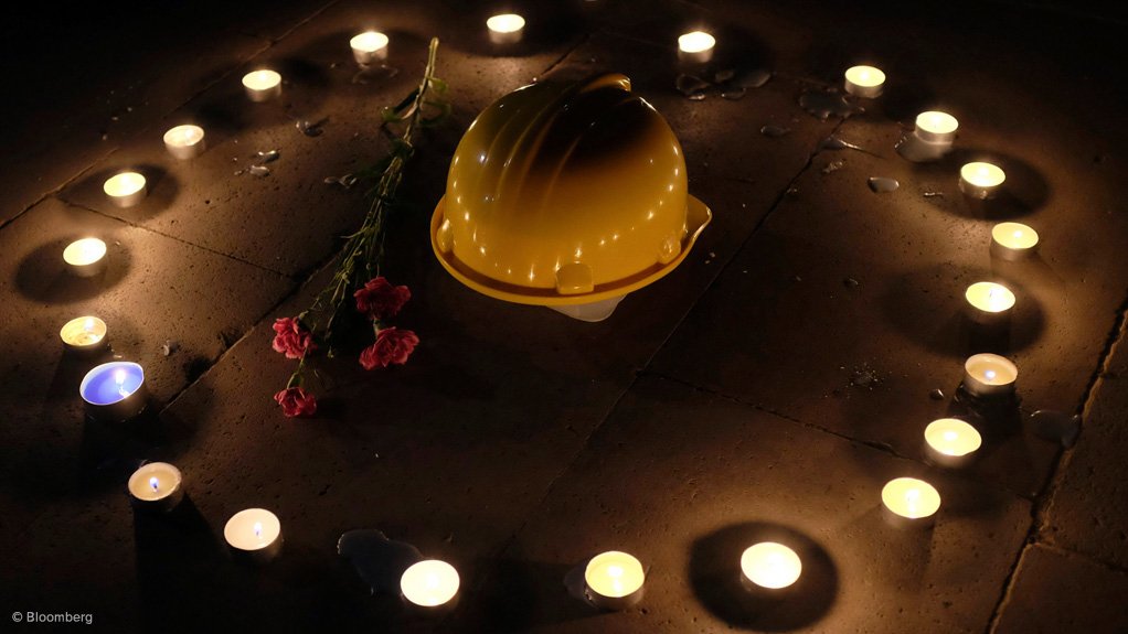 A mining helmet and carnations are seen placed on the ground by demonstrators during a candlelight vigil for the victims of the 2014 Soma mining disaster in western Turkey.