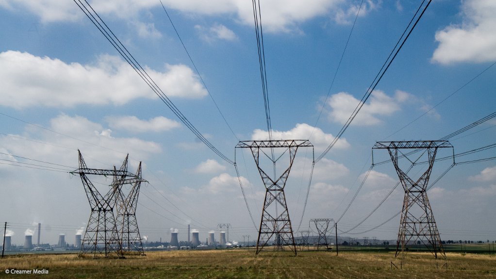 Transmission lines with Sasol's Secunda complex in the background, where synthetic fuels and chemicals are produced from coal