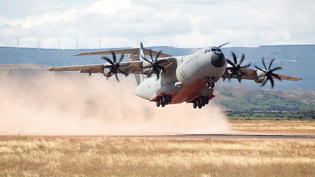 An A400M takes off from an unpaved airstrip