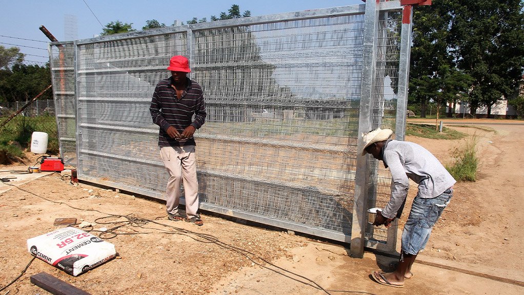 Contract workers Mogale Neo and Donation Monyela putting the touches to the vehicular access gate of Nkowankowa Industrial Park ahead of the launch next week 