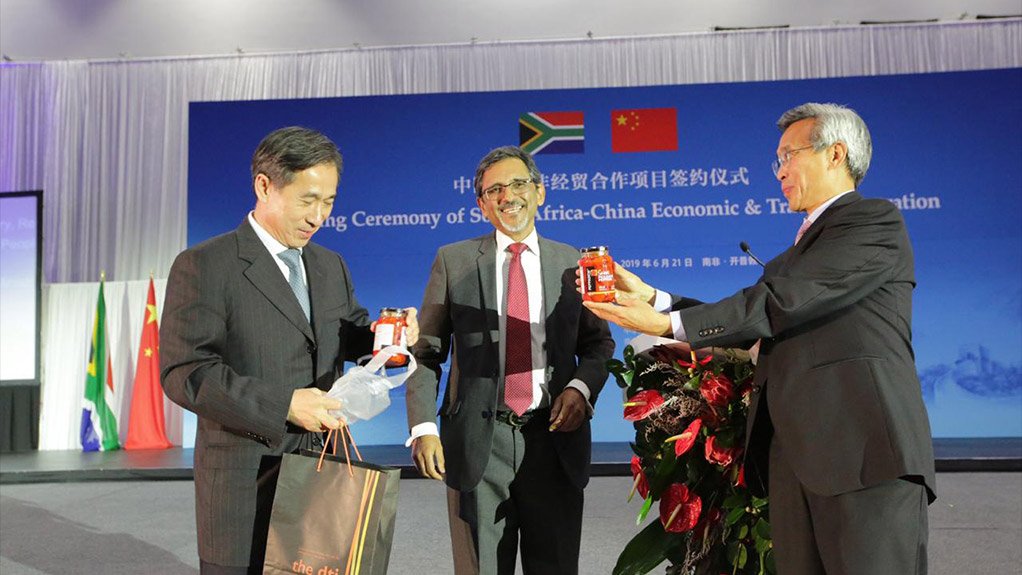 Trade and Industry Minister Ebrahim Patel handing peppadews to Chinese Assistant Minister of Commerce Ren Hongbin and Ambassador Lin Songtian as part of promoting Proudly SA products 