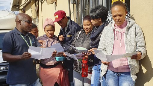 Go George community liason officer Simphiwe Schaap (far left) explaining to staff how to use the bidirectional routing on Route 14 to their benefit