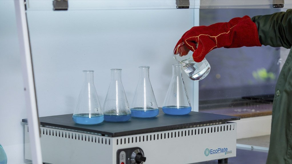 A Clariant technician in laboratory mixing chemical solutions and demonstrating how the flotation process is undertaken on a small scale 