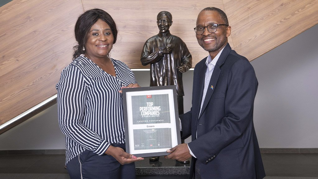 Top Companies representative Judy Twaambo Chileshe handing over certificate to CEO Mxolisi Mgojo 