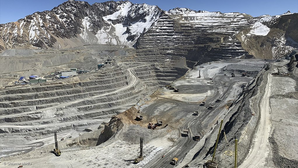 Los Bronces opencast copper mine with ice-capped Andes mountain range in sight.