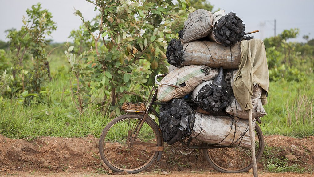 DOUBLE-EDGED SWORD Mine-developed road infrastructure can provide community members with greater accessibility, but can also lead to increased deforestation by people who rely on charcoal burning as an income source