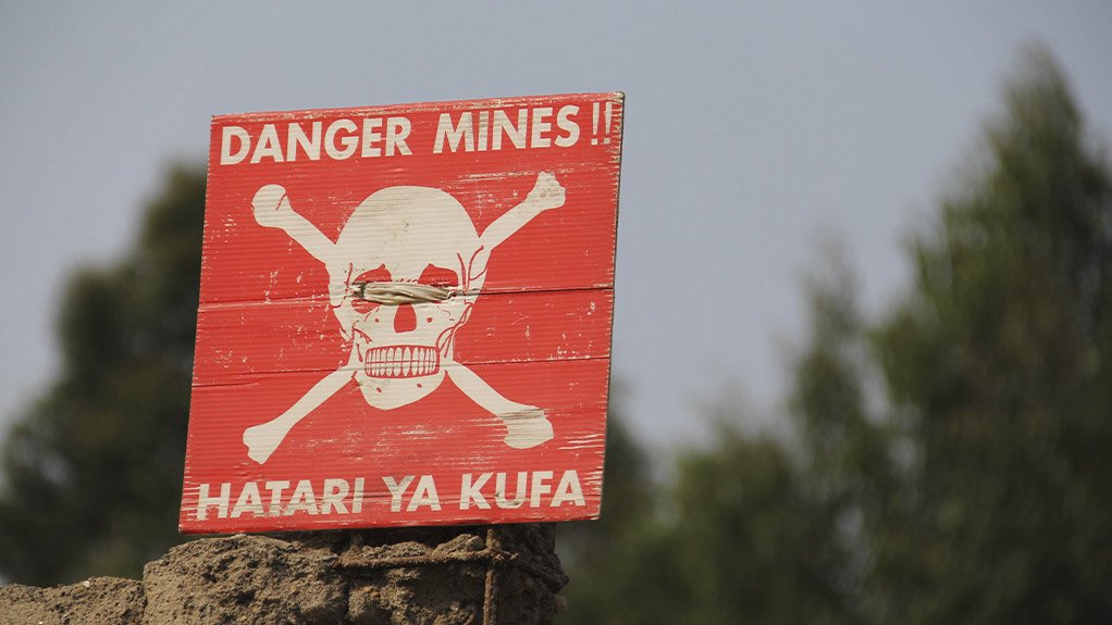 RISK OF DYING
A skull and crossbones with a dire warning written in Swahili warns miners of the risks surrounding mining