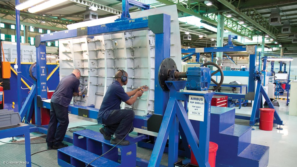 Denel Aerostructures workers assembling a fuselage top shell for an Airbus A400M military airlift aircraft, back in 2013