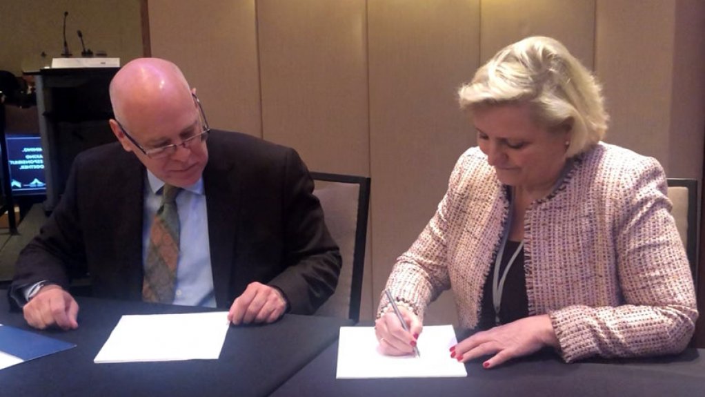 Norwegian mining industry secretary general Anita Hall signing an agreement at the PDAC  in Toronto on Monday.