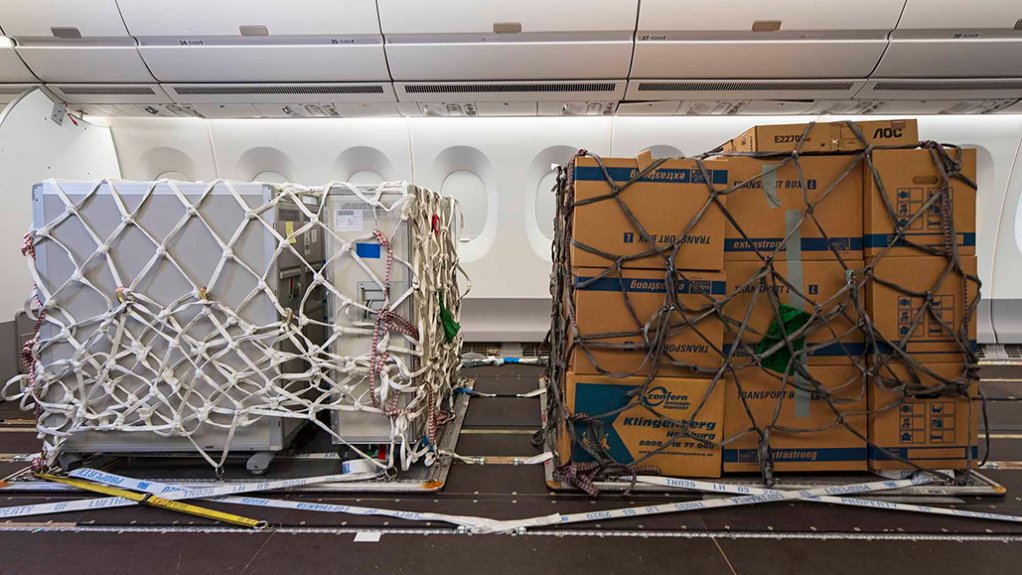 Cargo pallets locked on to cabin floor seat tracks on an Airbus airliner 