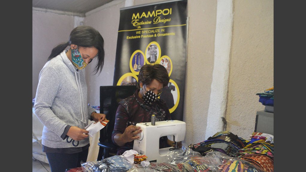 The owner of Mampoi Exclusive Designs, Mampoi Zwane in her studio, creating and designing face masks 