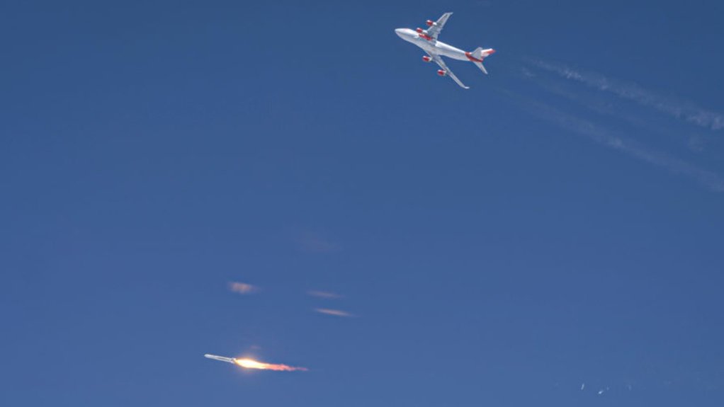 LauncherOne (bottom of picture) successfully ignites its first stage after being dropped by Boeing 747 “Cosmic Girl” (climbing away at the top of the picture)